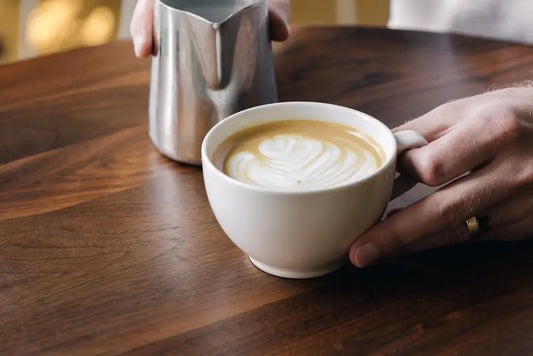 Coffee Roaster Near me - Barista holding a latte