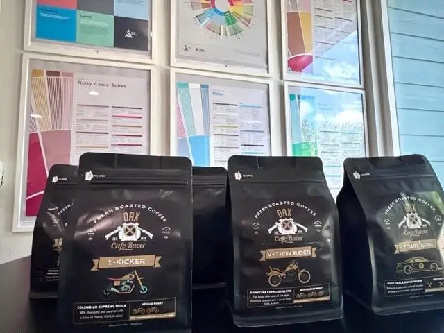 Freshly roasted medium and dark roast blend coffee beans in a bag with label featuring the DAX Cafe Racer logo